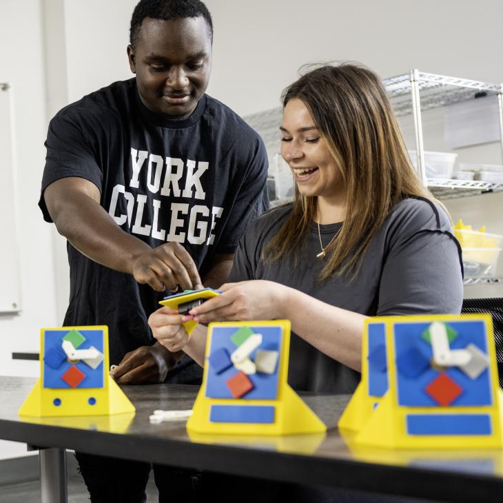 Two students work on a lesson in a classroom