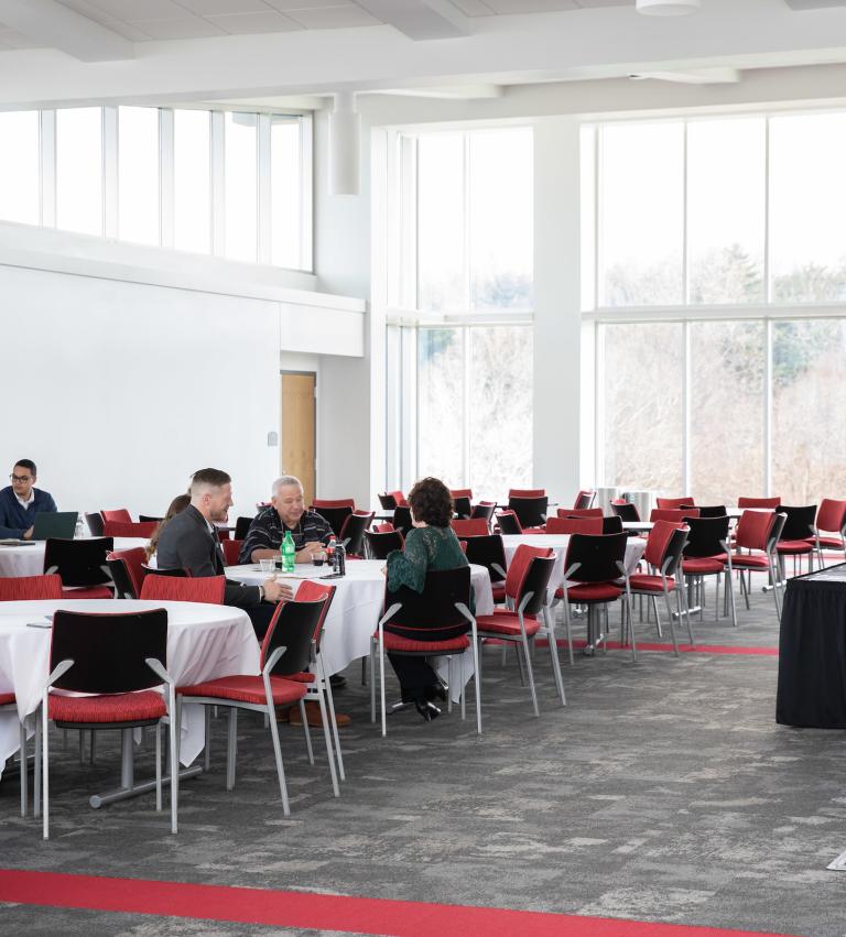 Tables and a podium fill the glass-walled Yorkview Hall corporate training center.