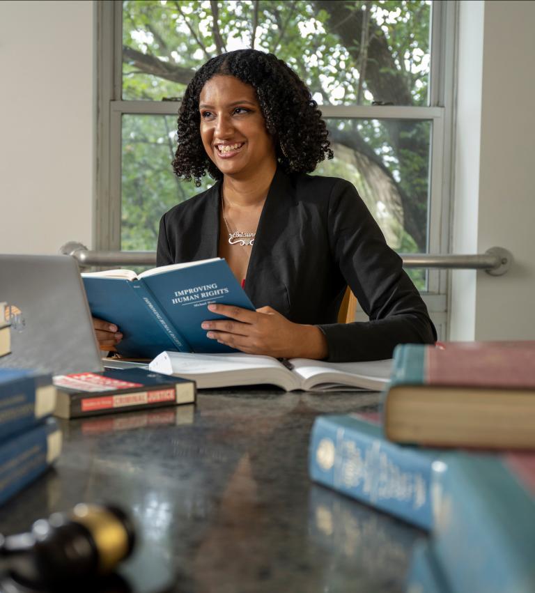 Smiling student studying in the library