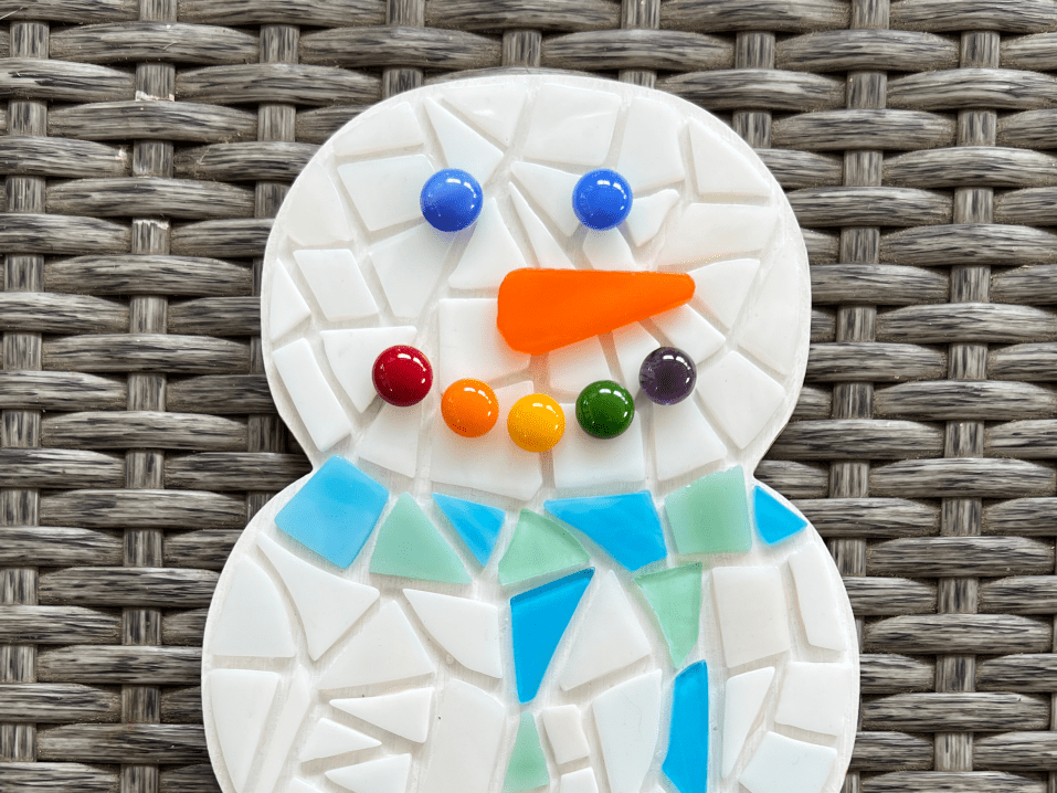 A mosaic craft creates the shape and pattern of a snowman.