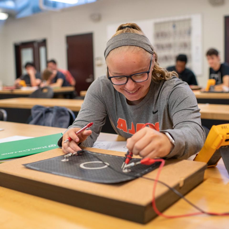 Student works on electrical engineering project in classroom