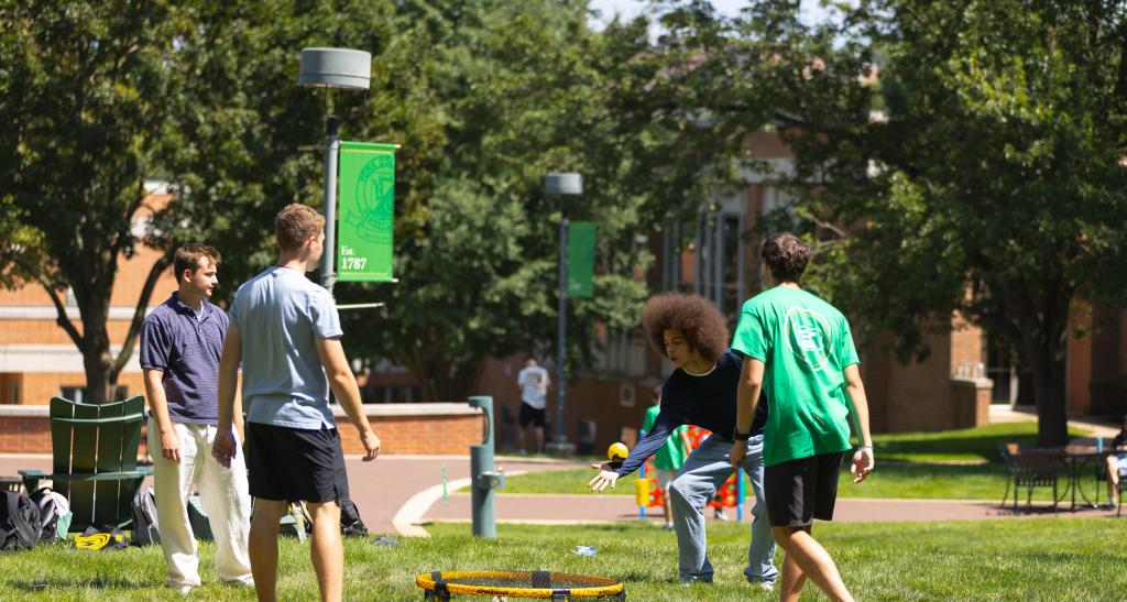 Students play lawn games outside on YCP campus.