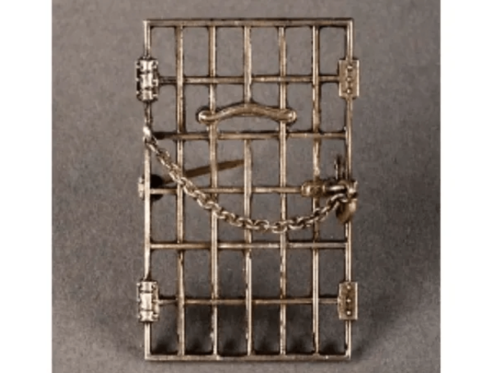 A "Jailed for Freedom" pin from 1917 made from bronze shaped as a jail cell door.