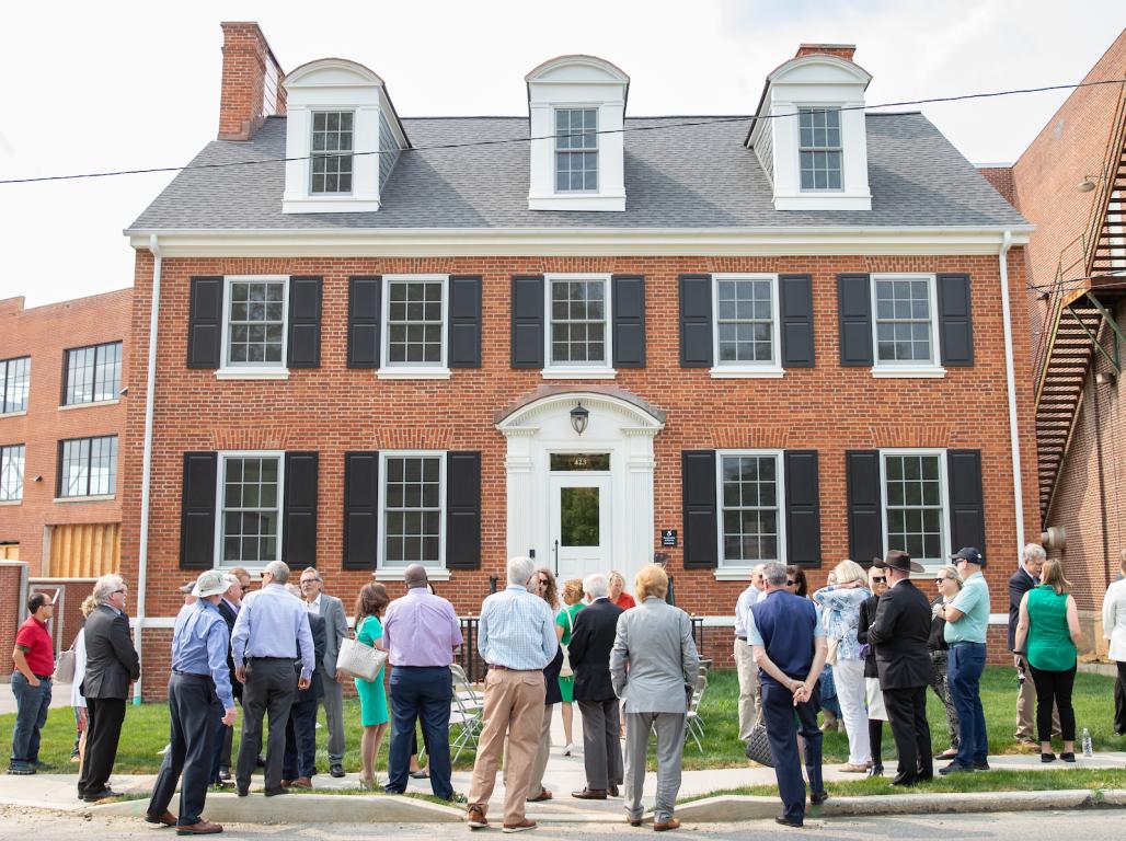 Members in front of the new Diehl house for the ribbon cutting ceremony.