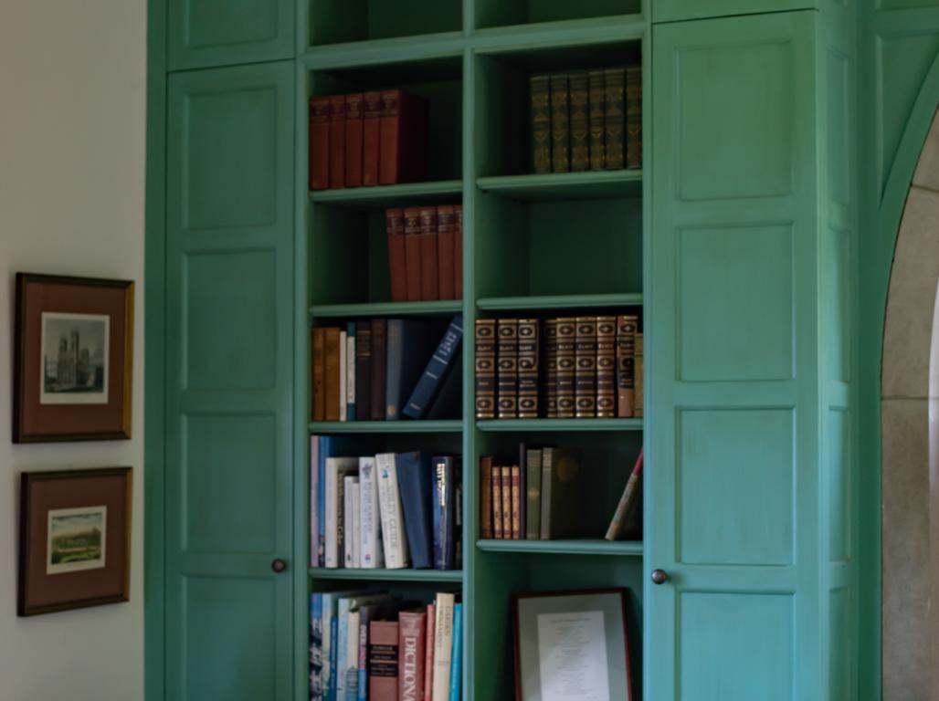 A green bookshelve in the Millbourne Gardens house.