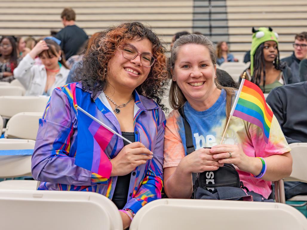 2 students holding up pride flags for York College's drag show