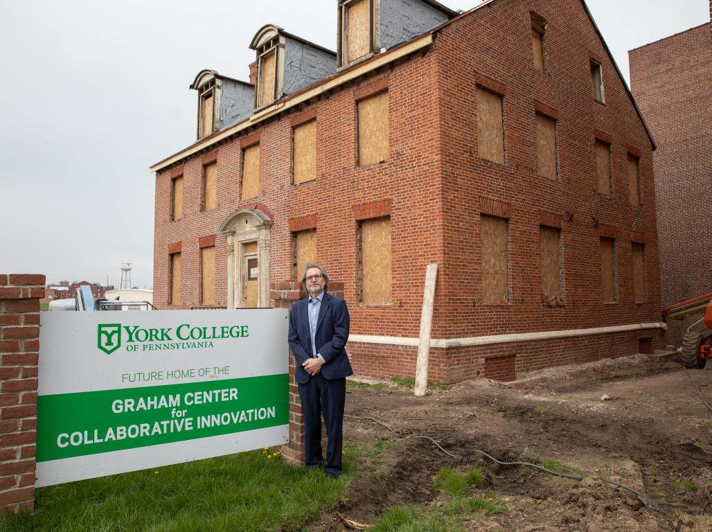 Dominic DelliCarpini standing in front of the future home for the Graham Center for Collaborative Innovation