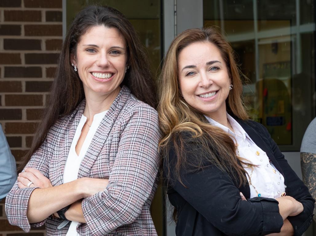 Drs. Amy Red and Rachael Lattanzio standing back to back with their arms crossed.