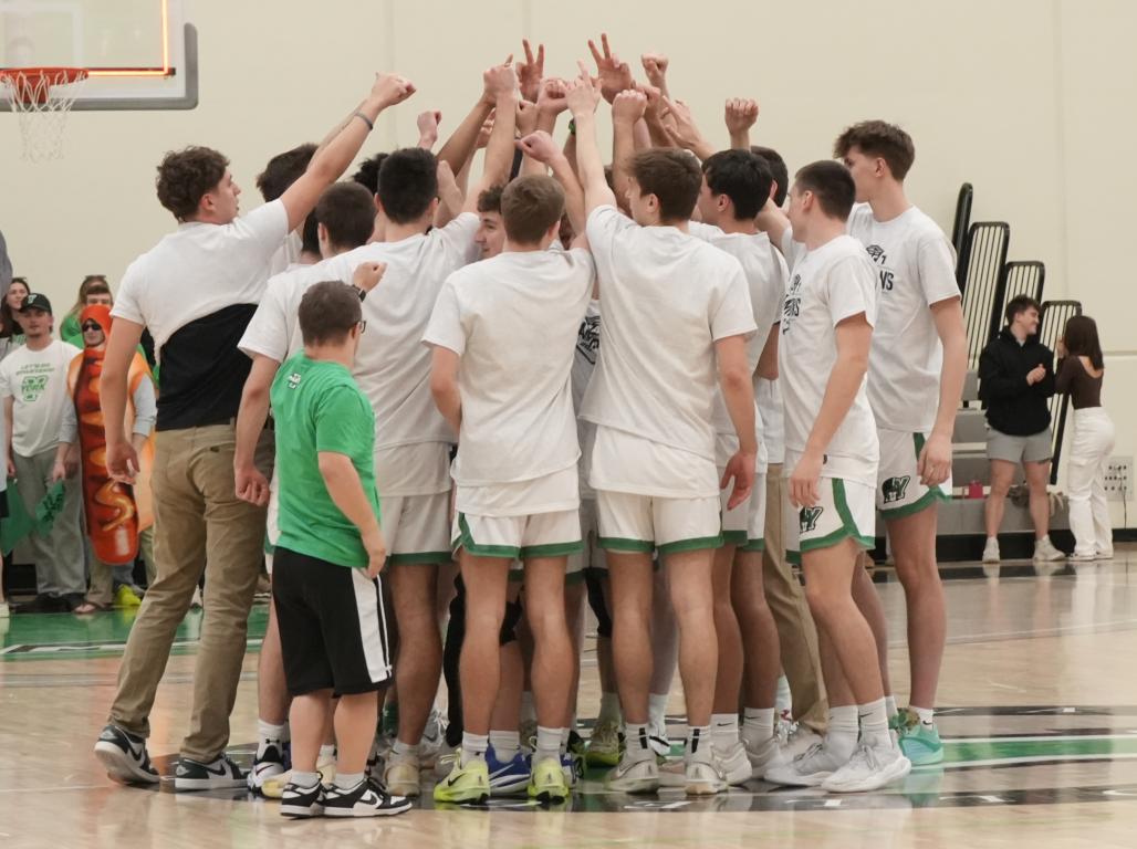 The York College Men’s Basketball team celebrating their win on the court