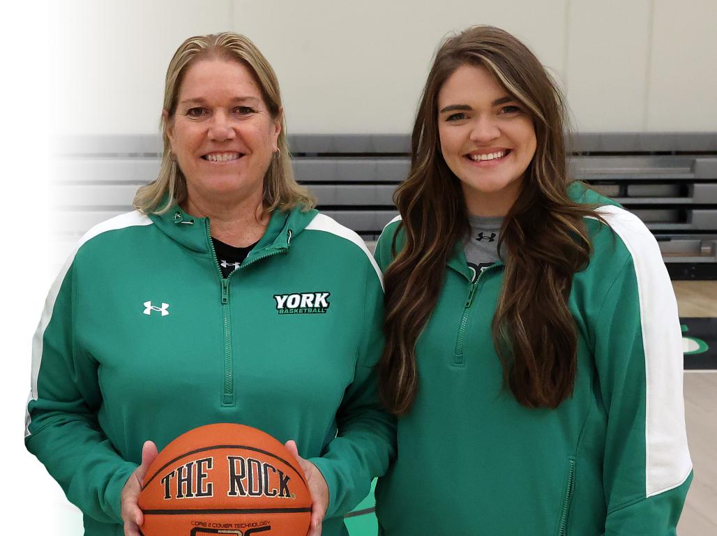 Basketball Coach Betsy Witman stands side by side with Spartan assistant coach and former standout player Katie Kilpatrick