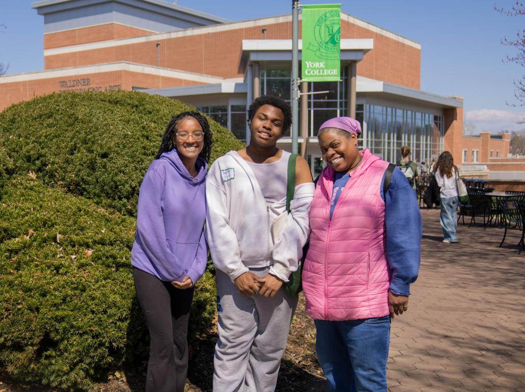 Andre Ford and family pose for a photo outside of the WPAC building at York College.