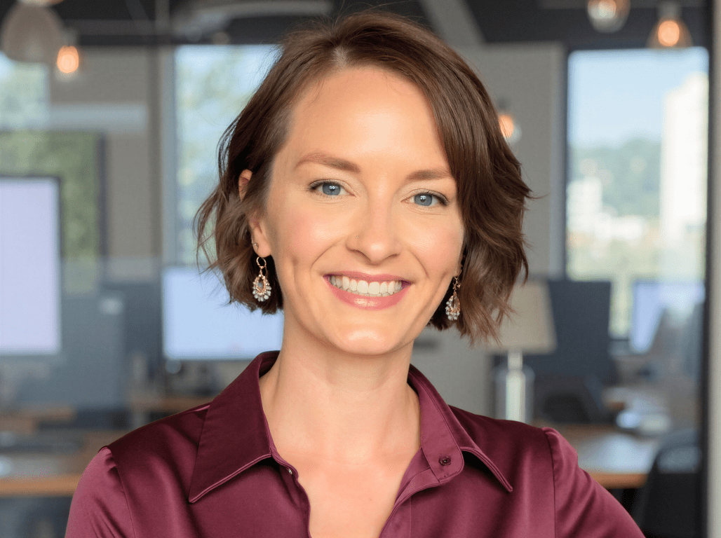 Portrait of York College alumna Sara Gagen ’11 smiling in a professional office setting.