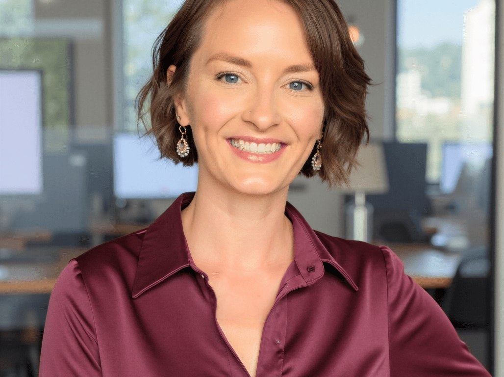 Portrait of York College alumna Sara Gagen ’11 smiling in a professional office setting.