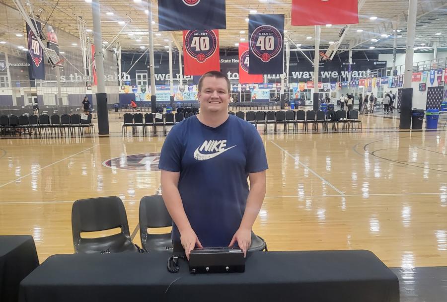 Austin Brown standing with a control device at the Spooky Nook Sports facility.
