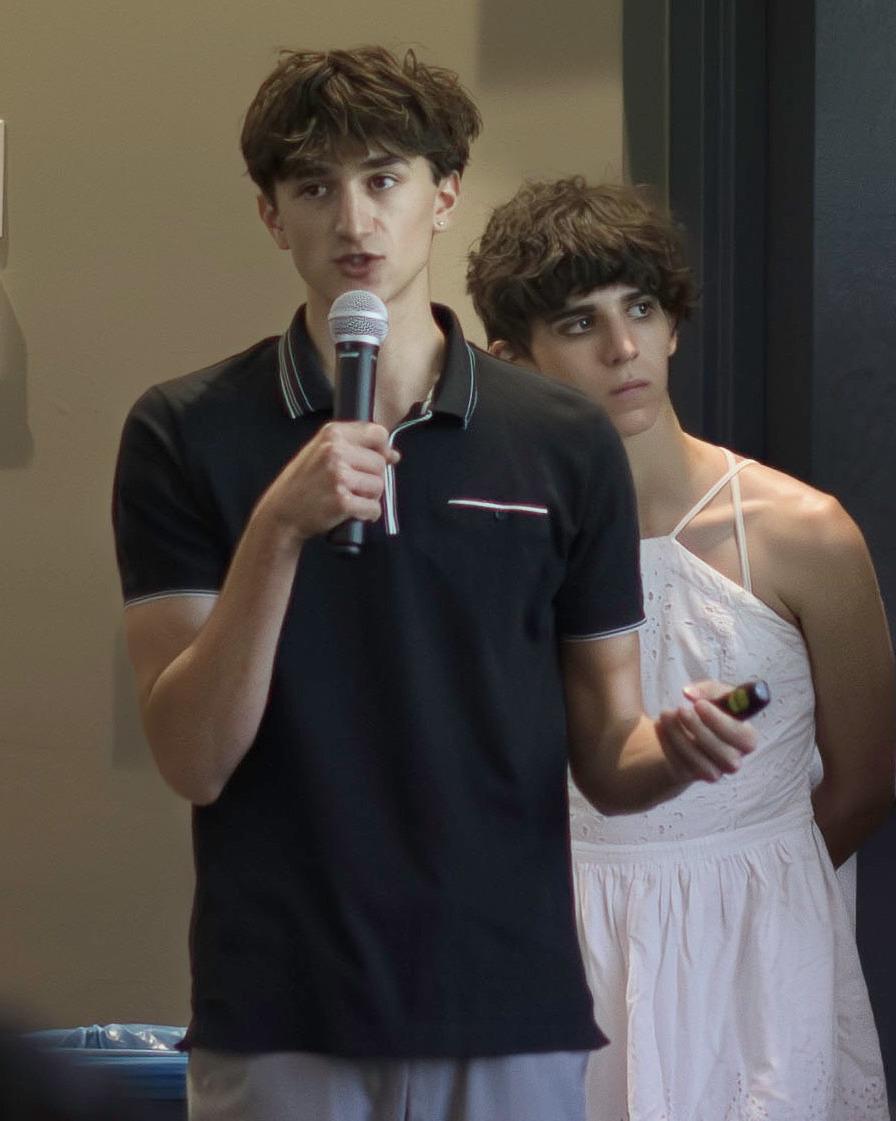 Alex Glatfelter stands with a microphone in his hand