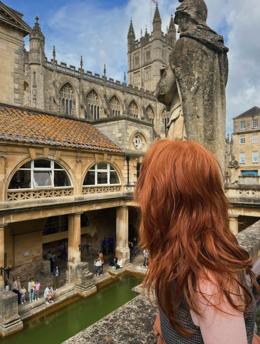 Person looking at an ancient building in Bath, England.
