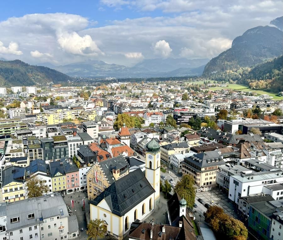 Scenic view of a European town with mountains visible in the distance.