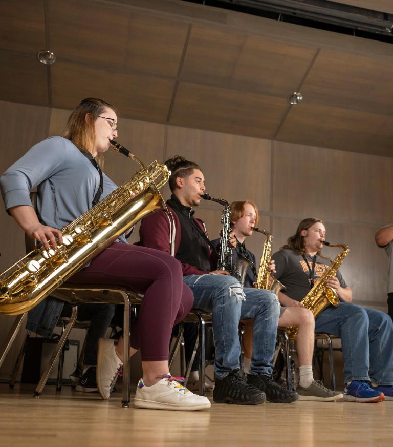 A group of students playing instruments in Demeester Hall.