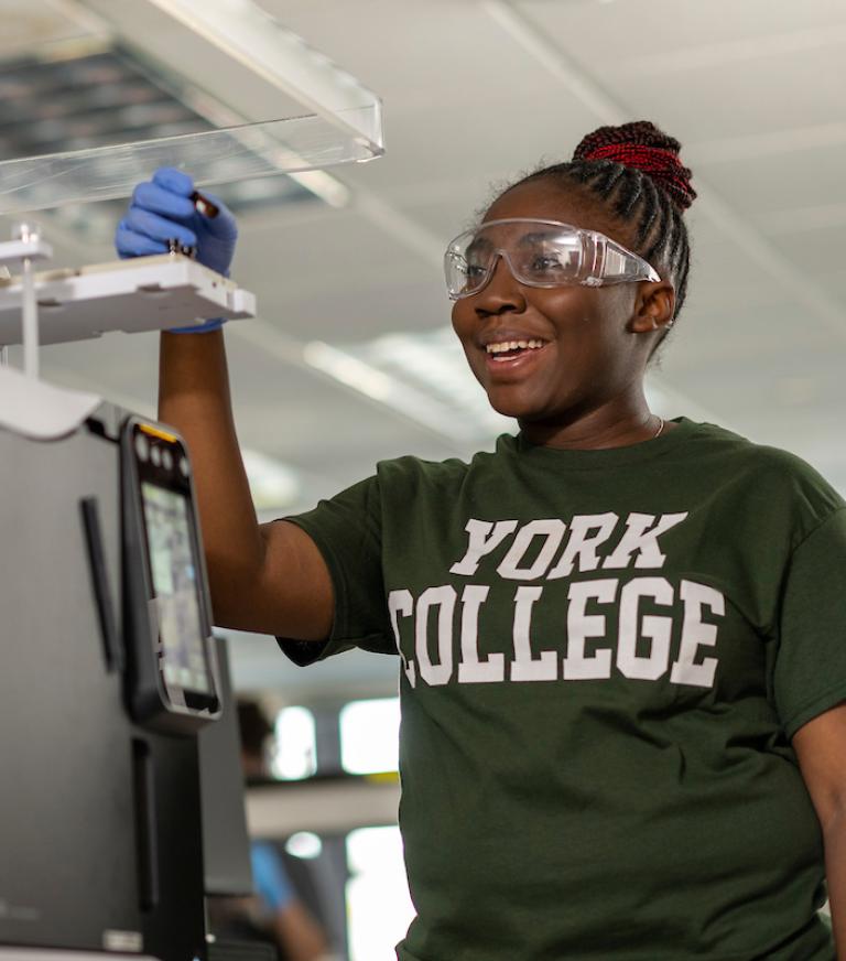 Student smiling in a chemistry lab.