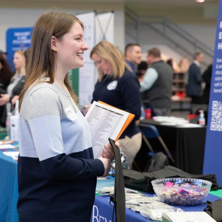 A student at Career Expo observing a table
