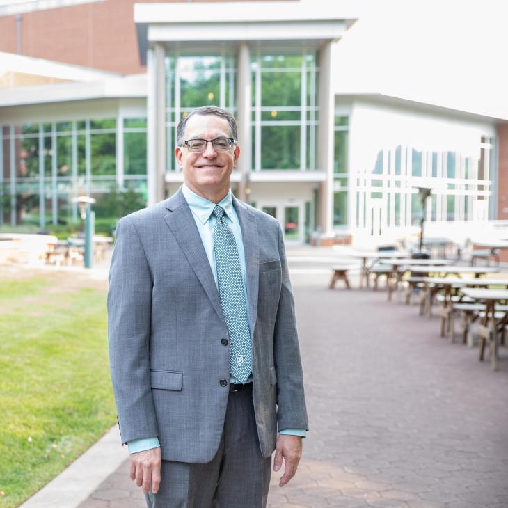 Dr. Burns in front of the Waldner Performing Arts Center.