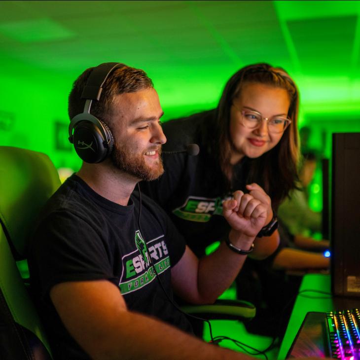 Two students playing an Esports game.