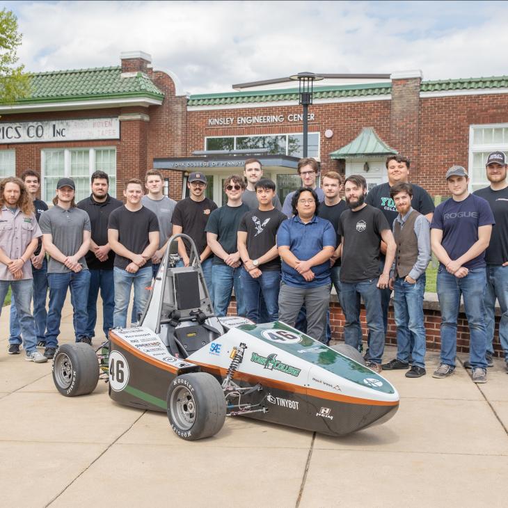 A group photo shows the YCP Racing Team standing by their car outside of the Kinsley Engineering Center.