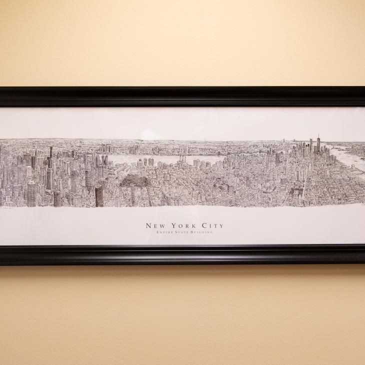 Black and white print drawing of New York City as viewed nearby from a tall building showing the notable skyline buildings.