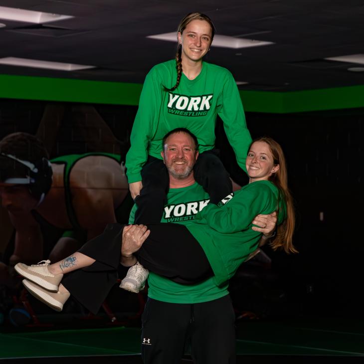 Brian Gross holds up his daughters Carly and Chloe