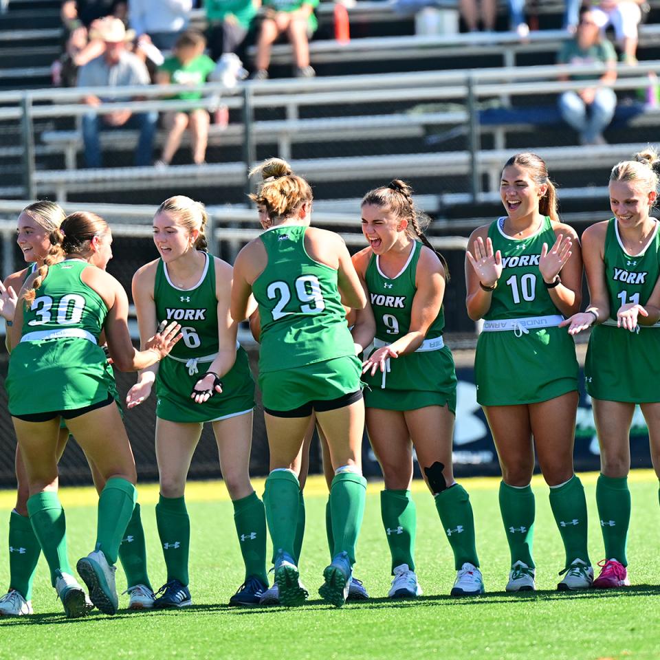 The YCP women's Field Hockey team lines up to slap hands