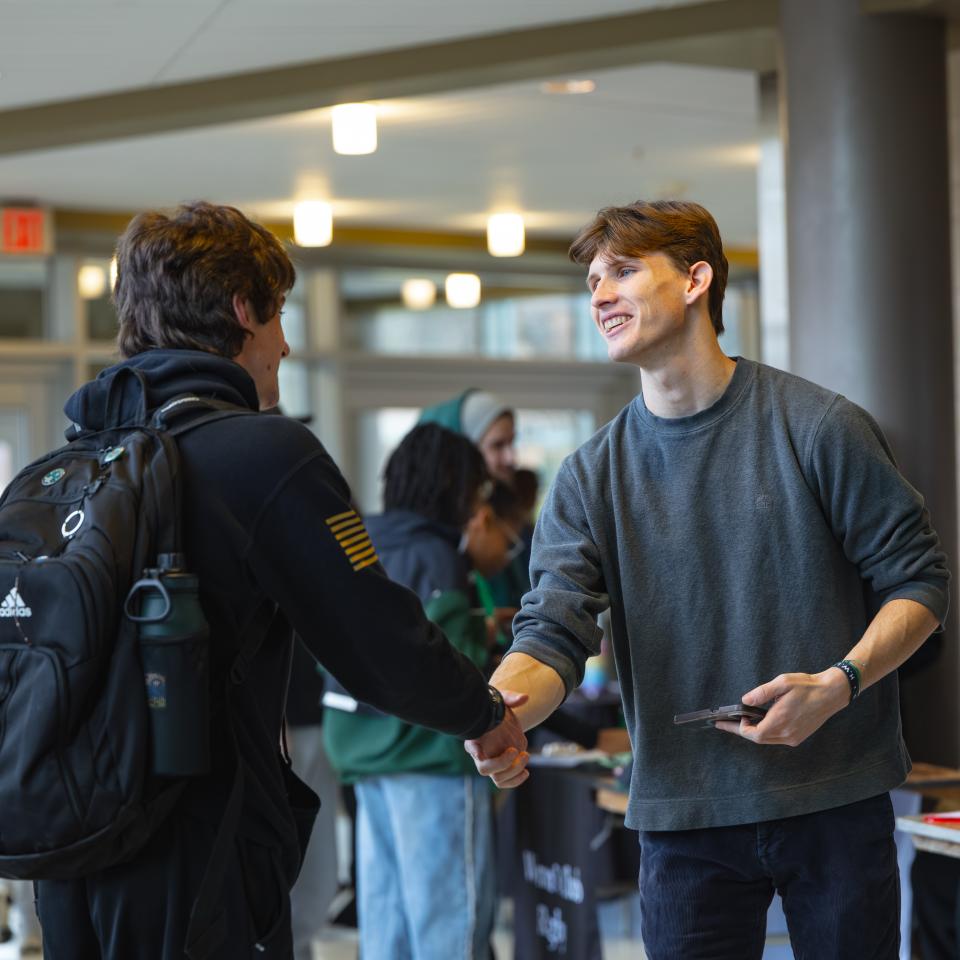 Top male students shake hands.